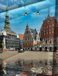 View of canal and buildings in city