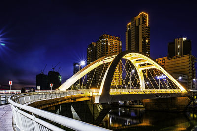 Illuminated bridge over river