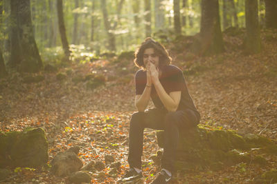 Woman sitting in forest