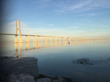 Bridge over sea against sky