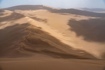 Nature and landscapes of dasht e lut or sahara desert with sand dunes and cloudy evening sky