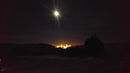 Scenic view of landscape against sky at night