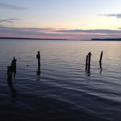 Reflection of clouds in sea at sunset