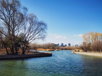 Scenic view of river against blue sky