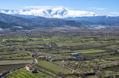 Scenic view of field and mountains against sky