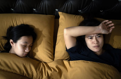 Portrait of cute boy lying on bed