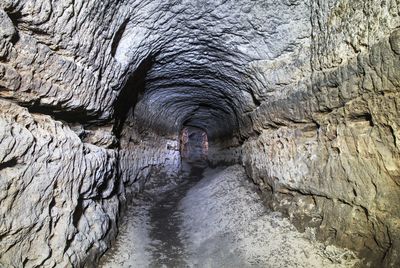 Old sandstone water tunnel, mined caves. sandstone tunnel moistened walls. dry channel underground