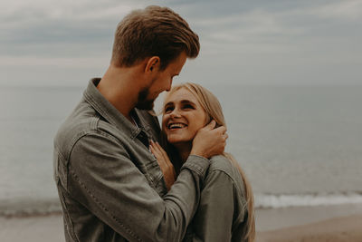 Side view of young woman looking at beach