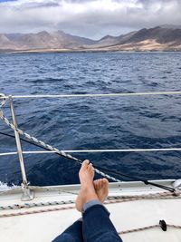 Low section of man relaxing on sailboat