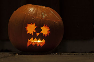 Close-up of illuminated pumpkin against black background