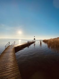 Pier over lake against sky