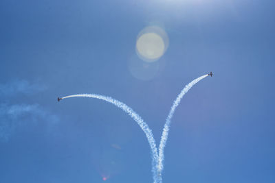 Low angle view of airplane flying against sky