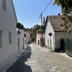 Empty road amidst buildings in town