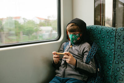 Rear view of man sitting in train