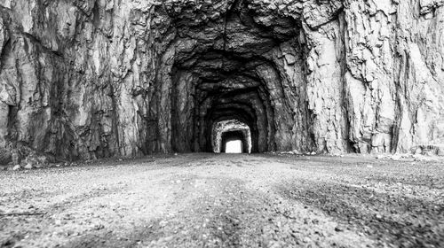 Rear view of man walking in tunnel