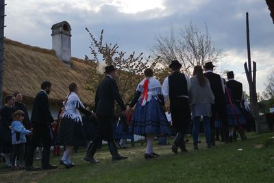 People standing on grass against sky