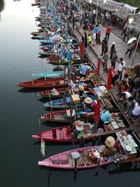 High angle view of vendors selling food on boats moored in river