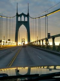 St john bridge against cloudy sky seen from car windshield during sunset