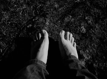 Low section of man sitting on field