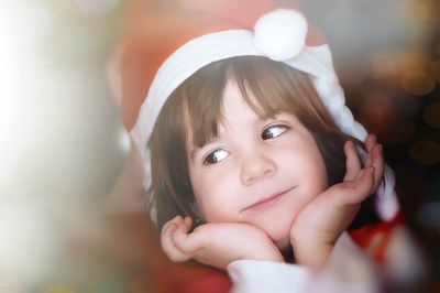 Close-up of cute girl wearing santa hat