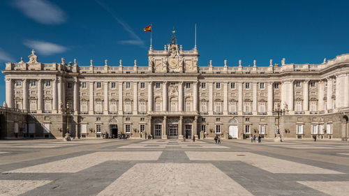 Facade of historic building in city against sky