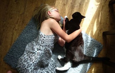 High angle view of girl with cat