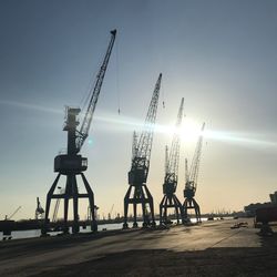 Cranes at construction site against sky