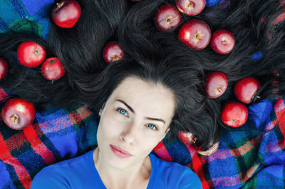 High angle portrait of woman lying with apples