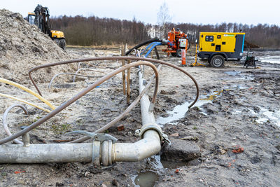 Wellpoint installation to get rid of high groundwater, visible metal and plastic pipes.