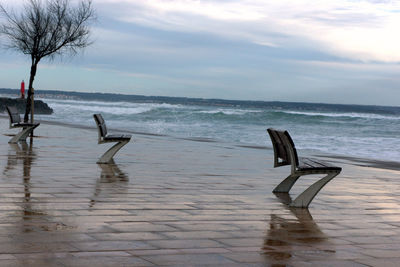 Empty benches overlooking calm sea