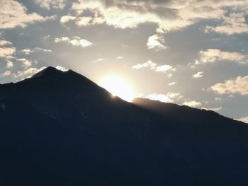 Scenic view of silhouette mountains against sky at sunset