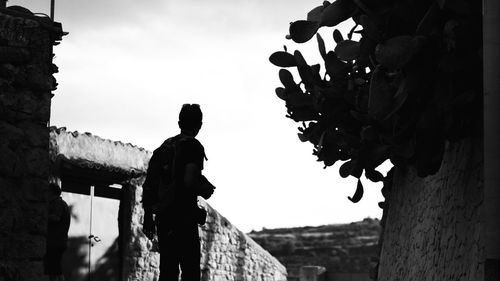 Side view of silhouette man standing against wall