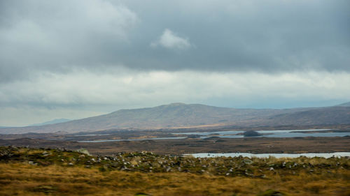 Scenic view of mountains against cloudy sky