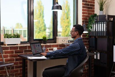 Businessman working on laptop in office