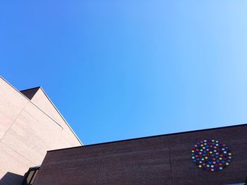 Low angle view of building against clear blue sky