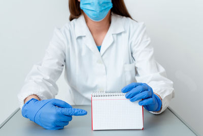 Midsection of woman wearing mask