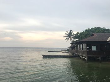 View of swimming pool by sea against sky