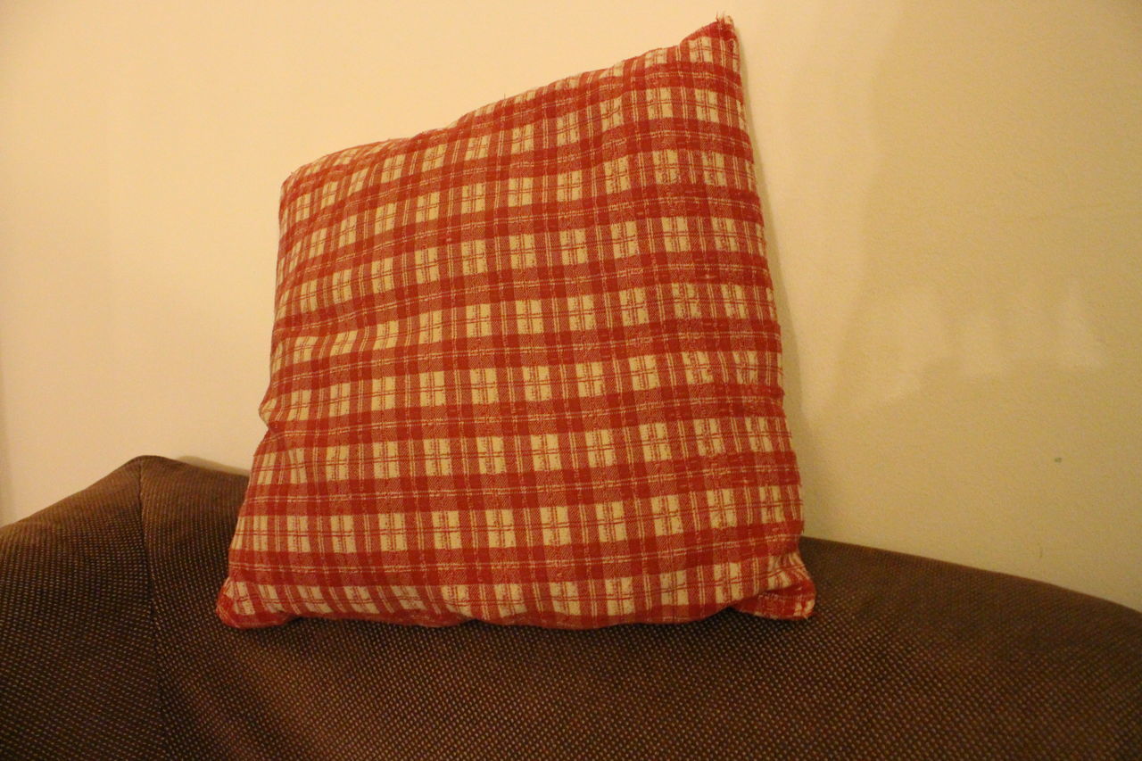 CLOSE-UP OF SOFA AGAINST WALL