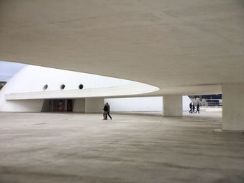 Rear view of woman walking in corridor