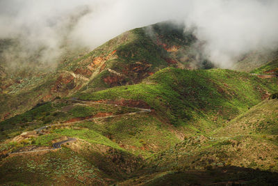 Scenic view of mountains in foggy weather