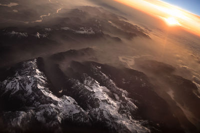 Aerial view of sea against sky during sunset