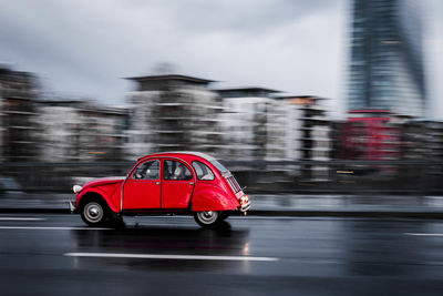 Red car on road in city