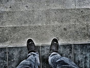 Low section of man standing on ground