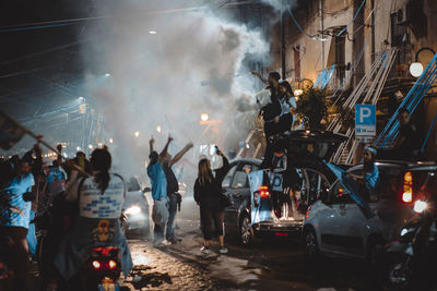 Group of people on the street celebrating football victory