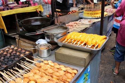 Man preparing food at market stall