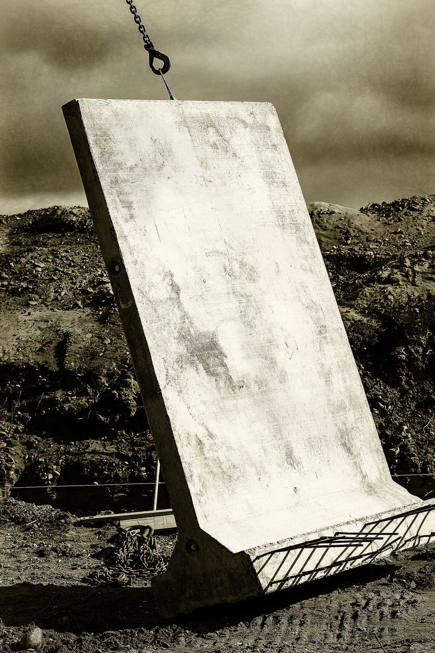 LOW ANGLE VIEW OF METAL STRUCTURE ON FIELD