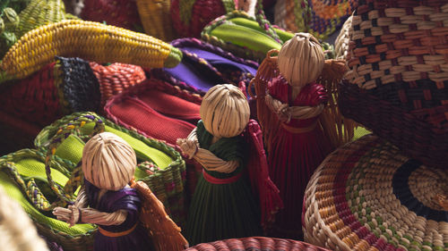 Handmade straw dolls at market stall