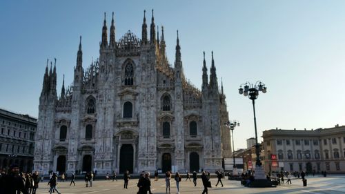 People at milan cathedral against clear sky