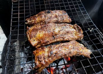 High angle view of meat on barbecue grill