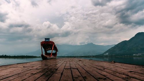 Pier on lake against sky